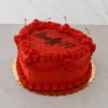 Vibrante pastel en forma de corazón en color rojo brillante con una cubierta superior de destellos comestibles rojos. Está decorado con bordes clásicos de concha y guirnaldas entrelazadas, cerezas al marrasquino con tallo y el mensaje "Finally 21" en elegante caligrafía negra. Castillo's Cake Shop.