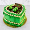 Divertido pastel en forma de corazón con temática de Shrek. Cuenta con una base de glaseado verde vibrante y un diseño de "pantano" en la superficie con un charco de chocolate oscuro y esferas verdes tridimensionales simulando burbujas. Está decorado con gruesos bordes de glaseado en verde y crema, detalles de enredaderas colgantes y un letrero que dice "Beware OGRO". Castillo's Cake Shop.