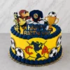 Pastel redondo en color amarillo brillante con bordes de rosetones azul marino, inspirado en el Club América. El frente luce un gran escudo del equipo, acompañado de imágenes de balones en los costados. La parte superior está decorada con la mascota del equipo, una camiseta, un trofeo dorado y un letrero de "HAPPY BIRTHDAY" en azul y dorado. Castillo's Cake Shop.