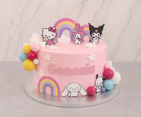 Hermoso pastel de un piso en color rosa pastel con temática de Sanrio. En el frente lleva el nombre "Genesis" en relieve rosa, acompañado de tiernos arcoíris en tonos pastel, nubes, pequeñas flores blancas y racimos de coloridas esferas. Está decorado con adorables recortes de los personajes Hello Kitty, My Melody, Kuromi y Cinnamoroll. Castillo's Cake Shop.